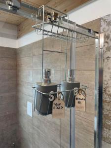 a room with two buckets and signs on the wall at Casa dei pazzi Montanari da Cristina in Alfedena +38 photos