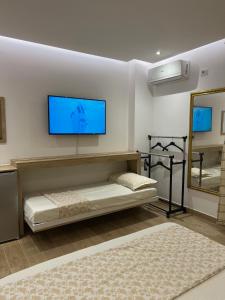 a living room with a flat screen tv on the wall at Best Summer Apartment in Golem +134 photos