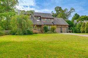a house with a large yard in front of it at Pet-Friendly Apt with Hot Tub Near the Hamptons! in Aquebogue