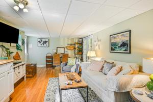 a living room with a couch and a table at Pet-Friendly Apt with Hot Tub Near the Hamptons! in Aquebogue