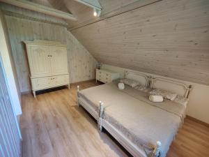 a bedroom with a bed and a wooden ceiling at River Mind Villa with SPA in Zalioji +65 photos