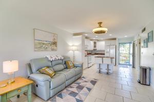 a living room with a couch and a kitchen at 2 Mi to Fort Pierce Jetty Coastal Florida Condo in Fort Pierce
