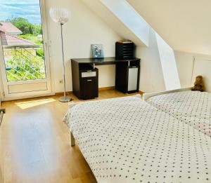 a bedroom with a bed and a desk with a window at Beausoleil SPA Villa XL-Geneva & Lake & Mountains-Wilena Home, Full Love in Chens-sur-Léman