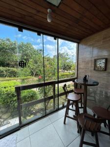 a room with a table and chairs and a large window at flat serra negra - bezerros - PE flat 007 - 009 in Bezerros