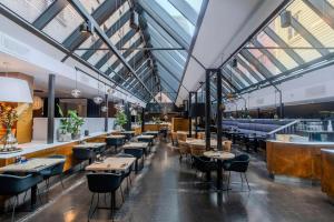 a restaurant with tables and chairs and windows at Radisson Blu Royal Hotel, Bergen in Bergen