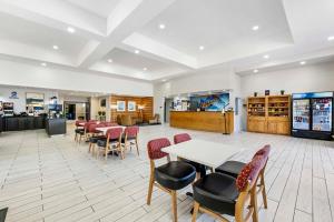 a waiting room with tables and chairs in a restaurant at Best Western Lubbock West Inn & Suites in Lubbock