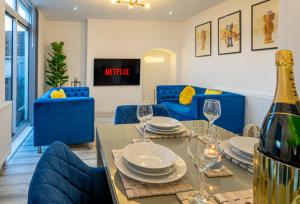 a dining room with a table and blue chairs at The Hive in Coventry