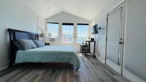 a bedroom with a bed and a large window at Lake Sammamish Waterfront Cabin in Sammamish