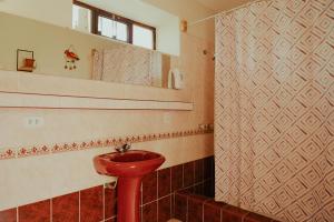 a bathroom with a red sink and a mirror at Kinti Wasi Casa de Campo Hospedaje in Los Baños del Inca +61 photos
