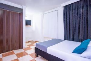 Postel nebo postele na pokoji v ubytování Casa Hotel Impacto