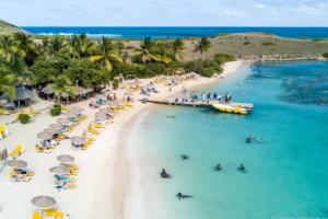 an aerial view of a beach with people in the water at Chez Anne - TilaCaz in Marigot