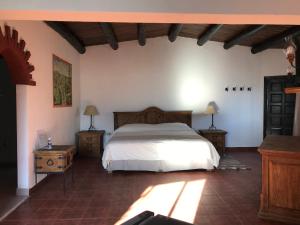 a bedroom with a large bed and two night stands at Parador del Alma in Creel
