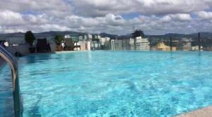 a large swimming pool on top of a building at Mabolo Garden Flats Bnb in Cebu City