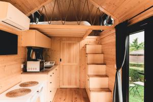 a tiny house with a kitchen and a living room at Paradise Home by Tiny Away in Bessé-sur-Braye