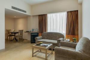 a living room with a couch and a table at Greenpark Visakhapatnam in Visakhapatnam