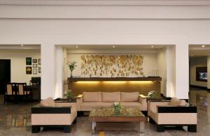 a living room with a couch and a table at Greenpark Visakhapatnam in Visakhapatnam
