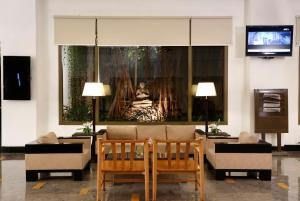 a living room with a couch and a painting on the wall at Greenpark Visakhapatnam in Visakhapatnam