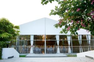 a glass building with a group of people in it at Greenpark Visakhapatnam in Visakhapatnam