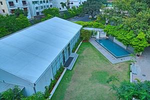 an overhead view of a building with a swimming pool at Greenpark Visakhapatnam in Visakhapatnam