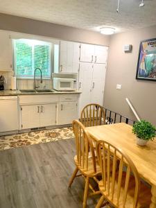 a kitchen with a wooden table and chairs at E. Turkeyfoot Whole House in Akron