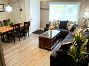 a living room with a couch and a table at The House Hotels - 4 Beds, huge yard, secluded, and central! in Akron