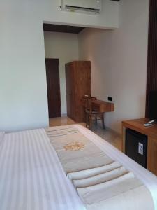Postel nebo postele na pokoji v ubytování Sujiwa Ubud Hotel & Villa