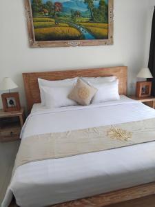 Postel nebo postele na pokoji v ubytování Sujiwa Ubud Hotel & Villa