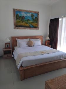 Postel nebo postele na pokoji v ubytování Sujiwa Ubud Hotel & Villa