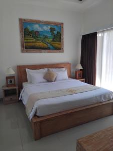 Postel nebo postele na pokoji v ubytování Sujiwa Ubud Hotel & Villa