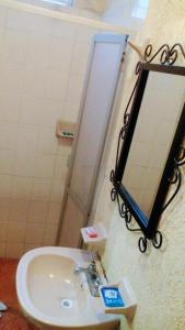 a bathroom with a sink and a mirror on the wall at Hotel Casa Galena in Morelia +35 photos