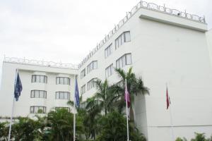a white building with flags in front of it at Greenpark Visakhapatnam in Visakhapatnam