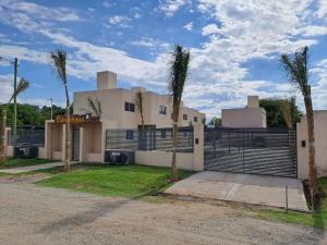 a house with palm trees in front of it at Baumhaus in Villa Anizacate