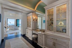 a kitchen with a large cabinet with a mirror at Luxury Villa in La Punta Estates, Enjoy 3,000 Usd Credit for Thanksgiving in Punta Mita +24 photos