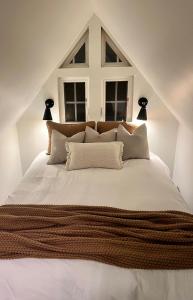 a bedroom with a large white bed with a window at Aframe of Mind Packwood in Packwood