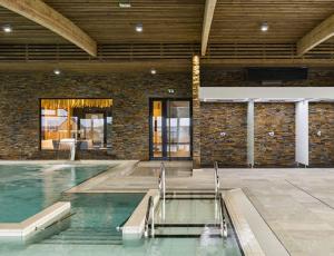a large indoor swimming pool in a building at Jolie maison de vacances in Concarneau