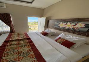 Postel nebo postele na pokoji v ubytování Batukaru Garden 5 Bali Sevilla Residence