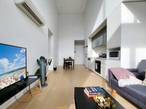 TV a/nebo společenská místnost v ubytování Your Quiet Penthouse with High Ceiling Split Level