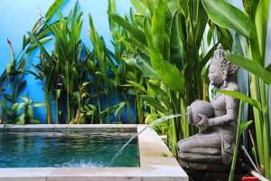 a stone statue sitting next to a swimming pool at Peacock Private Pool Villa, self check-in, Workspace, Kitchen in Dalung