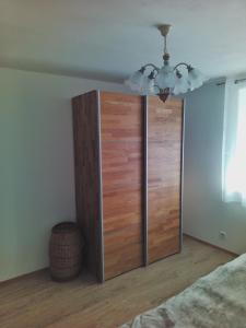 a large wooden cabinet in a bedroom with a ceiling at Guggenthaler Gipfelblick in Guggenthal