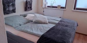 a bed with two pillows on it in a room at Die 2 Schwestern in Bad Sobernheim