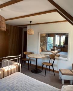 a bedroom with a bed and a table and chairs at Noclegi pod Słonecznikiem in Gąsawa
