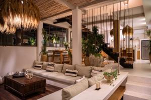 a living room with a couch and a table at Maison Matahari Apartment Canggu in Kuta