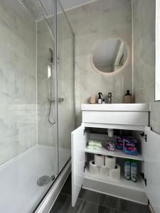 a white bathroom with a shower and a sink at The Hive in Coventry +40 photos