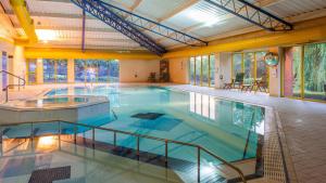 a large indoor swimming pool in a building at Holiday Inn Runcorn M56 Junction 12 by IHG in Runcorn
