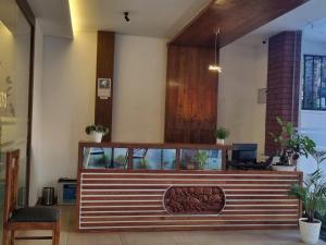a restaurant with a counter with plants on it at Hotel trees thekkady in Thekkady