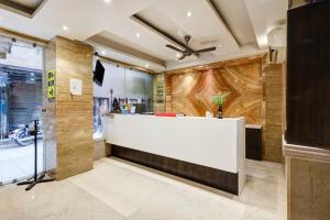 a lobby with a white reception desk in a building at HOTEL TASHKENT PALACE - Budget Friendly, Near R K Ashram Metro Station in New Delhi