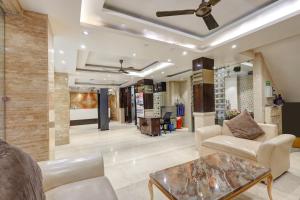 a living room with a ceiling fan and a table at HOTEL TASHKENT PALACE - Budget Friendly, Near R K Ashram Metro Station in New Delhi