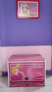 a barbie doll is sitting in a pink box at Villa Barbie Green Hill Cipanas Cianjur in Panyaweuyan