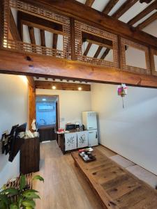 a large room with a kitchen and a living room at Yeonyijae hanok stay in Gyeongju