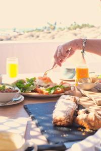 a person eating a plate of food on a table at Casa Serena 10 Boutique- Adults Only-Breakfast Included in Mácher